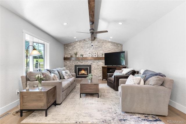 6795 E Kettle Ave, Centennial, CO 80112 - living area featuring wood finished floors, a ceiling fan, and a stone fireplace