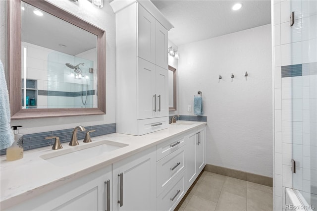 6795 E Kettle Ave, Centennial, CO 80112 - full bath featuring double vanity, tile patterned floors, a textured ceiling, and tub / shower combination