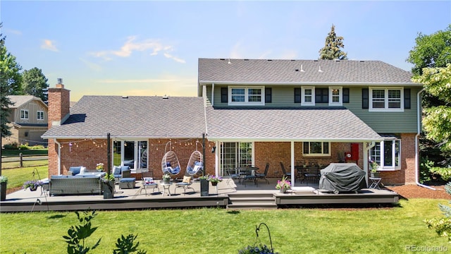 6795 E Kettle Ave, Centennial, CO 80112 - rear view of house with an outdoor living space, a wooden deck, and brick siding