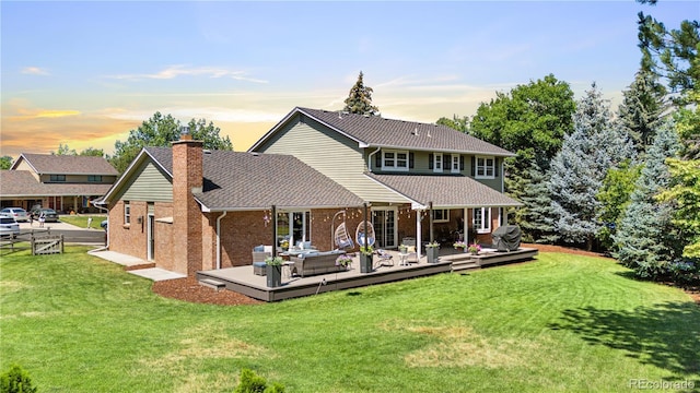 6795 E Kettle Ave, Centennial, CO 80112 - back of house with an outdoor living space, a deck, a chimney, and a lawn