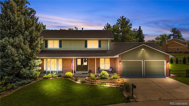 6795 E Kettle Ave, Centennial, CO 80112 - view of front facade featuring an attached garage, concrete driveway, a porch, and a yard