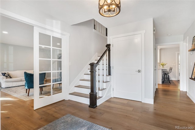 6795 E Kettle Ave, Centennial, CO 80112 - stairs with wood finished floors, a chandelier, and recessed lighting