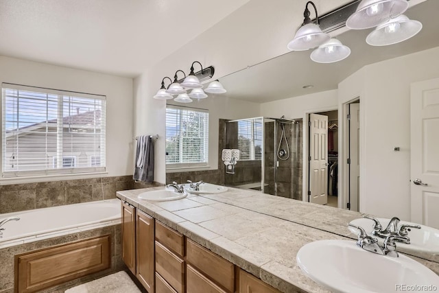 bathroom featuring vanity and shower with separate bathtub