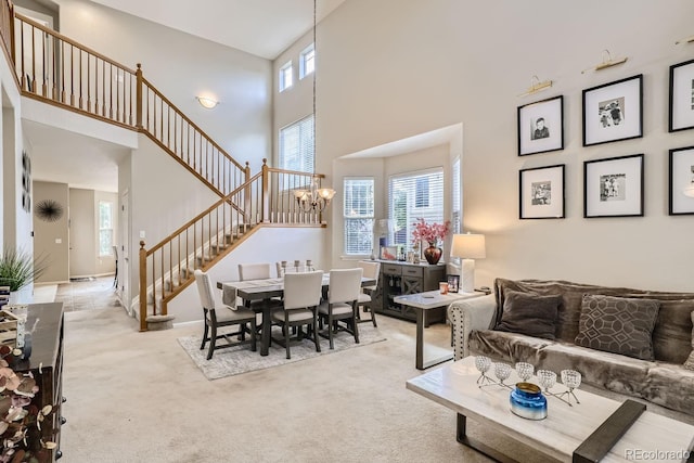 carpeted dining room with a chandelier, a towering ceiling, and a wealth of natural light