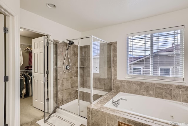 bathroom featuring independent shower and bath