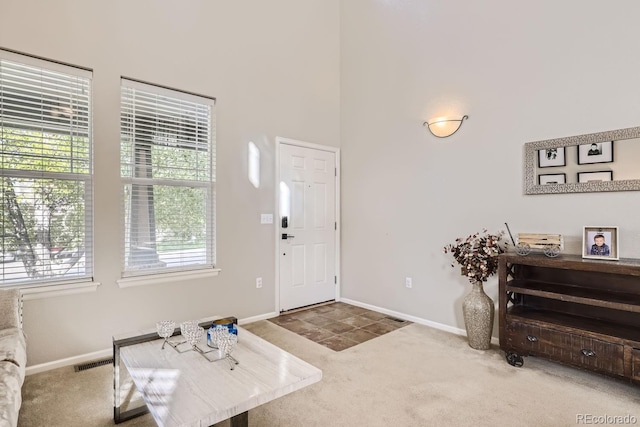 entrance foyer featuring plenty of natural light and carpet flooring