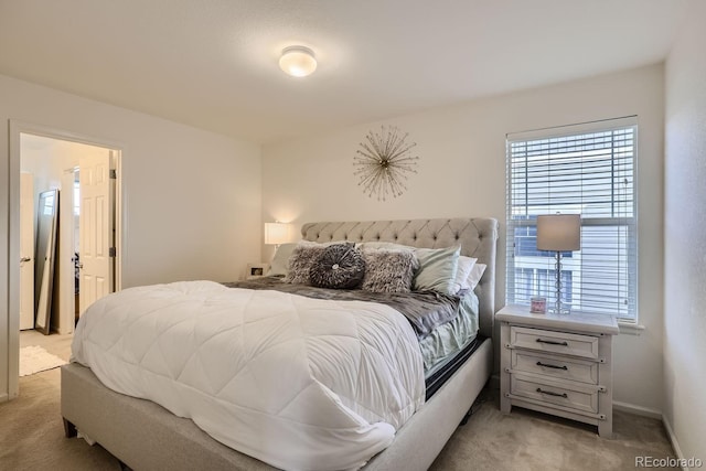 bedroom with multiple windows and light colored carpet