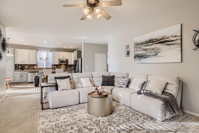 carpeted living room with ceiling fan