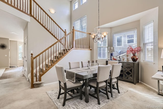 dining room with light colored carpet, a chandelier, and a healthy amount of sunlight