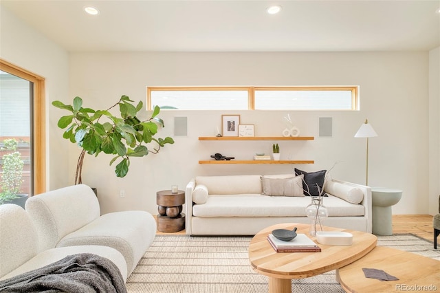 living area with recessed lighting, wood finished floors, and a healthy amount of sunlight
