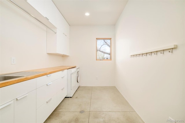 clothes washing area with recessed lighting and washer / dryer