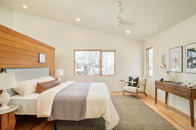 bedroom with vaulted ceiling, wood finished floors, recessed lighting, and a ceiling fan