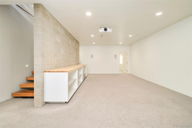 interior space featuring light carpet, recessed lighting, and stairway