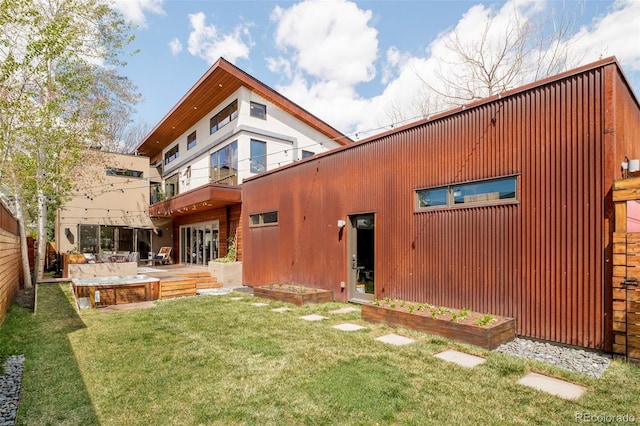 rear view of house featuring a yard, a patio, a balcony, and fence