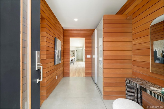 corridor with wooden walls and recessed lighting