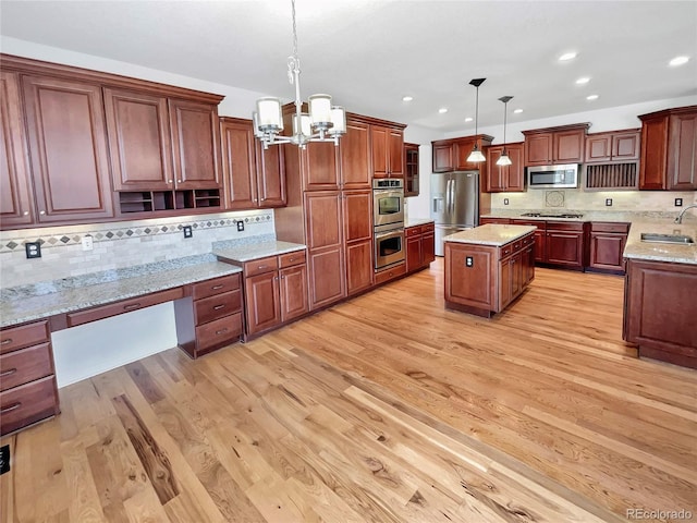 2180 Trailblazer Way, Castle Rock, CO 80109 - kitchen with appliances with stainless steel finishes, a sink, a chandelier, tasteful backsplash, and light wood-style floors