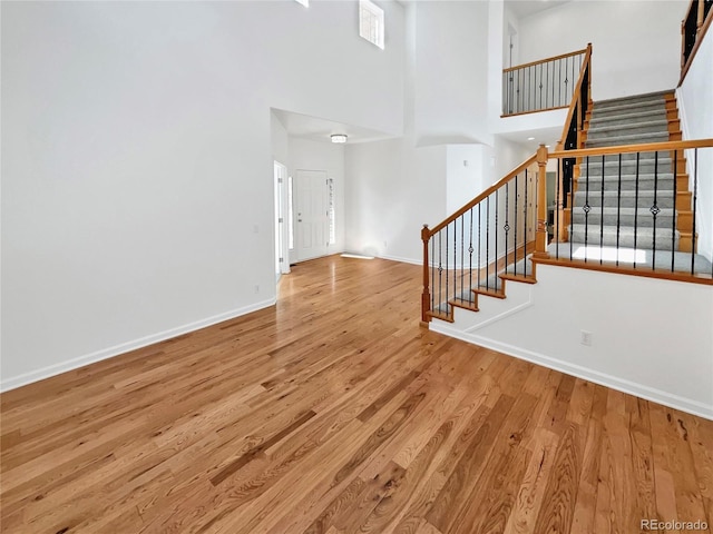 2180 Trailblazer Way, Castle Rock, CO 80109 - entrance foyer featuring a towering ceiling, wood finished floors, stairway, and baseboards