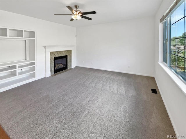 2180 Trailblazer Way, Castle Rock, CO 80109 - unfurnished living room featuring a ceiling fan, carpet, baseboards, and a fireplace