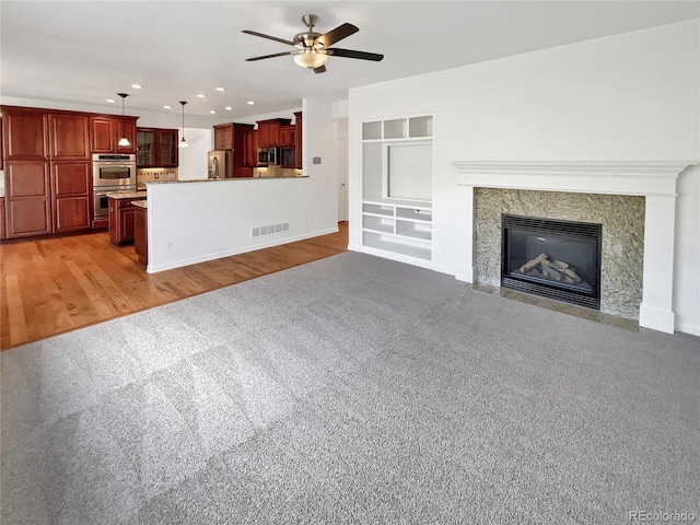 2180 Trailblazer Way, Castle Rock, CO 80109 - unfurnished living room featuring ceiling fan, recessed lighting, baseboards, built in features, and light wood-type flooring