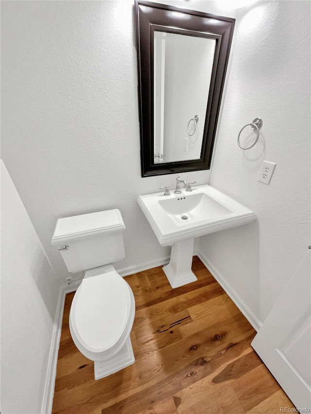 2180 Trailblazer Way, Castle Rock, CO 80109 - bathroom featuring toilet, wood finished floors, and baseboards