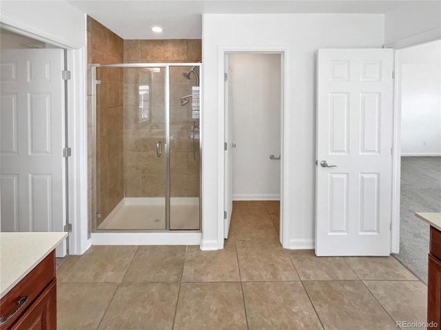 2180 Trailblazer Way, Castle Rock, CO 80109 - bathroom featuring vanity, a stall shower, tile patterned flooring, and baseboards