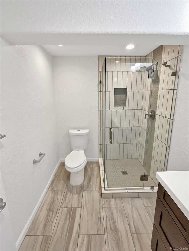 2180 Trailblazer Way, Castle Rock, CO 80109 - bathroom with a stall shower, toilet, baseboards, vanity, and a textured ceiling