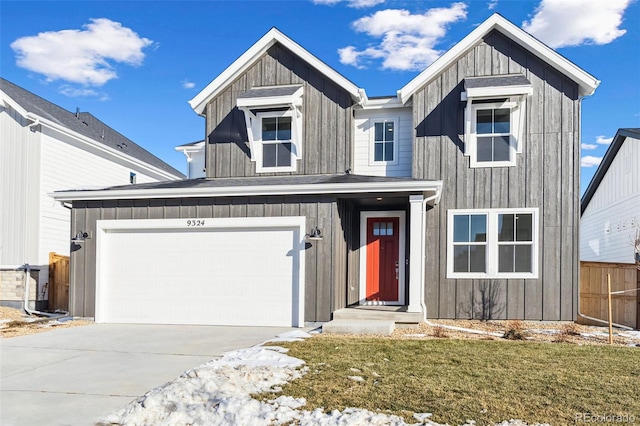 view of front of property with a garage and a front lawn