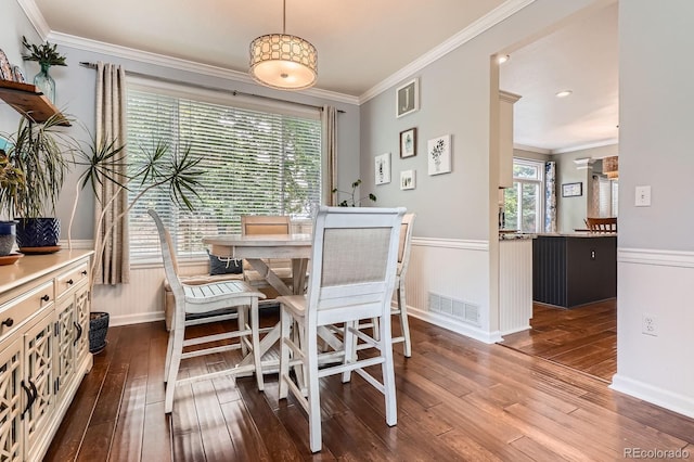 16341 Maple Rock Ct, Parker, CO 80134 - dining space with dark wood finished floors, ornamental molding, a wainscoted wall, and baseboards