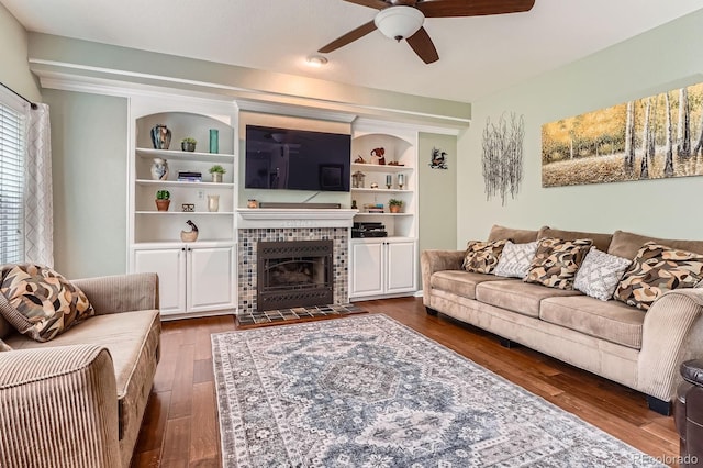 16341 Maple Rock Ct, Parker, CO 80134 - living room featuring ceiling fan, wood finished floors, a fireplace, and built in shelves
