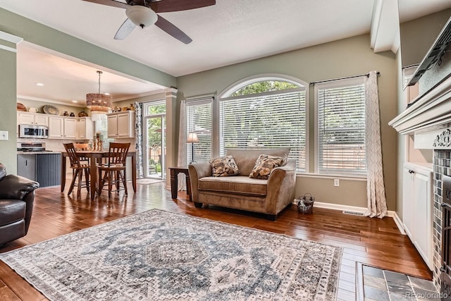 16341 Maple Rock Ct, Parker, CO 80134 - living room featuring a ceiling fan, hardwood / wood-style flooring, baseboards, a chandelier, and recessed lighting