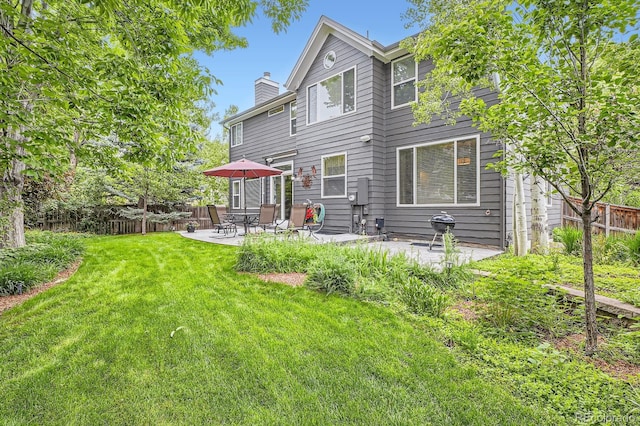 16341 Maple Rock Ct, Parker, CO 80134 - back of house with a chimney and a patio