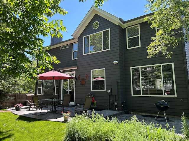 16341 Maple Rock Ct, Parker, CO 80134 - back of house featuring a patio and a chimney