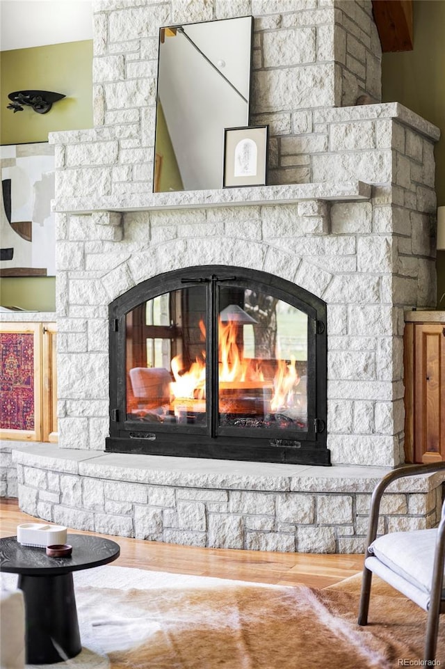 detailed view of a fireplace and wood finished floors