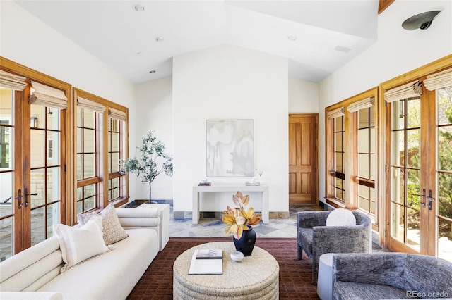 living area with french doors and high vaulted ceiling