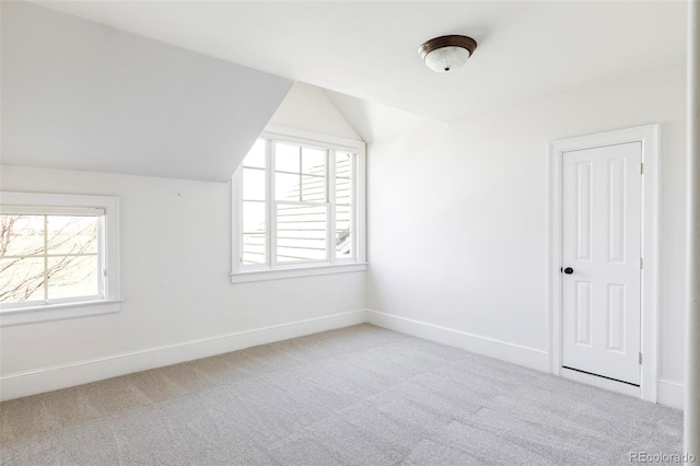 bonus room featuring lofted ceiling, carpet floors, and baseboards