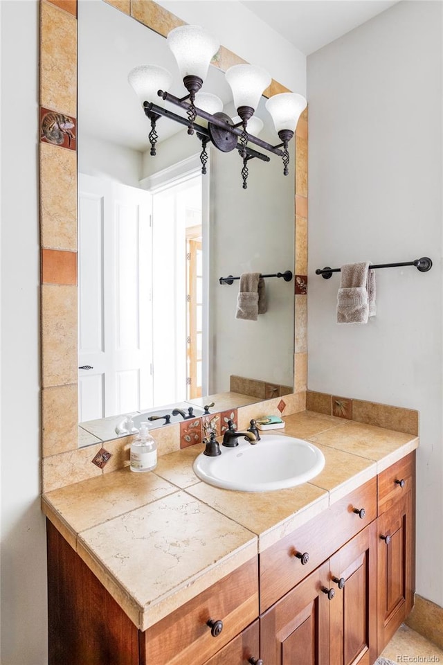 bathroom featuring vanity and a chandelier