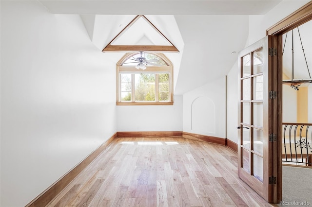 bonus room featuring vaulted ceiling, light wood finished floors, baseboards, and ceiling fan