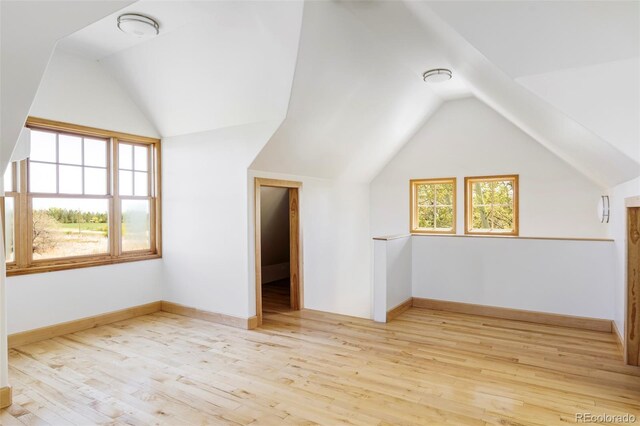 bonus room featuring vaulted ceiling, wood finished floors, and baseboards