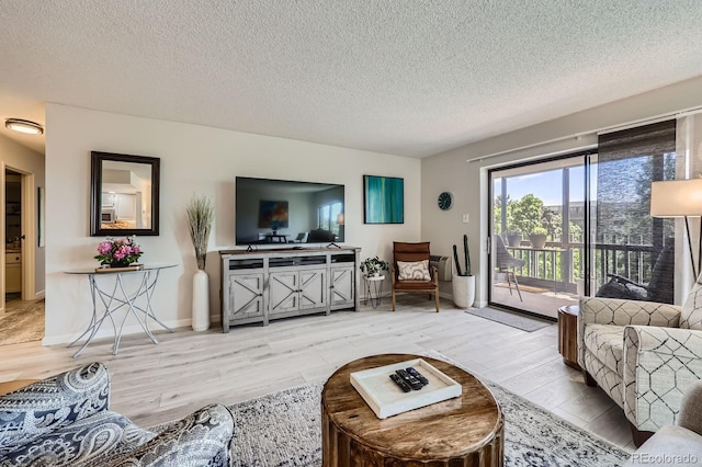 14390 E Marina Dr Unit 403, Aurora, CO 80014 - living room featuring wood finished floors, a textured ceiling, and baseboards