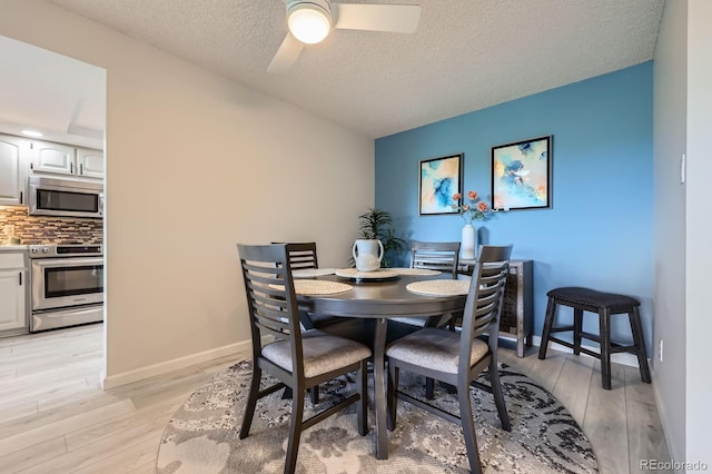 14390 E Marina Dr Unit 403, Aurora, CO 80014 - dining space with a ceiling fan, light wood-style flooring, a textured ceiling, and baseboards