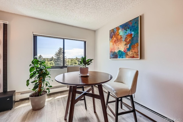 14390 E Marina Dr Unit 403, Aurora, CO 80014 - dining space featuring a textured ceiling, light wood-style flooring, and a baseboard heating unit