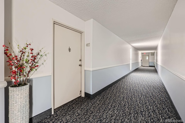 14390 E Marina Dr Unit 403, Aurora, CO 80014 - hallway featuring carpet floors and a textured ceiling