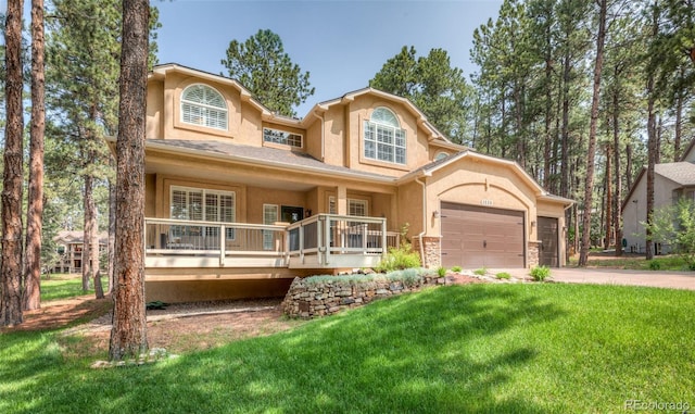 1530 Woodrose Ct, Colorado Springs, CO 80921 - view of front of home with a front lawn, stucco siding, concrete driveway, and an attached garage