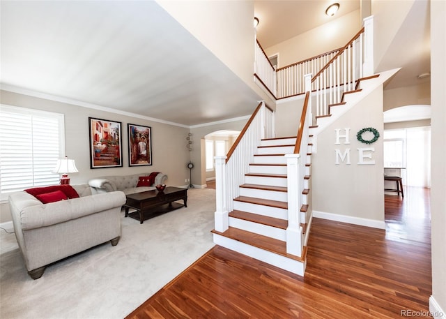 1530 Woodrose Ct, Colorado Springs, CO 80921 - living room with arched walkways, baseboards, stairway, wood finished floors, and ornamental molding