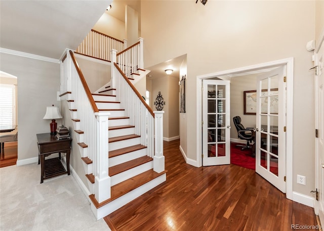 1530 Woodrose Ct, Colorado Springs, CO 80921 - staircase with french doors, baseboards, wood finished floors, a high ceiling, and ornamental molding