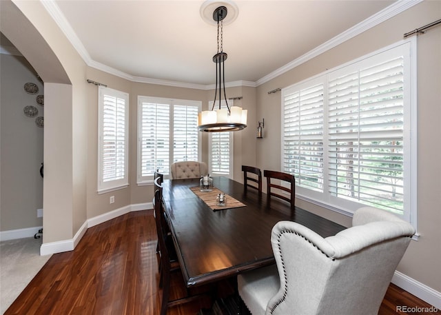 1530 Woodrose Ct, Colorado Springs, CO 80921 - dining space with plenty of natural light, arched walkways, dark wood-style floors, baseboards, and crown molding