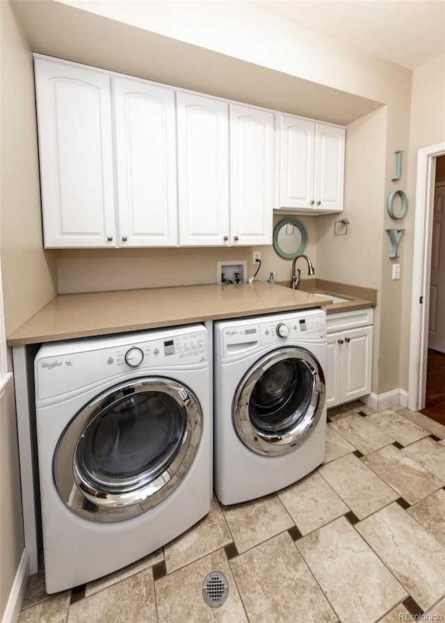 1530 Woodrose Ct, Colorado Springs, CO 80921 - washroom featuring washer and dryer, cabinet space, and baseboards