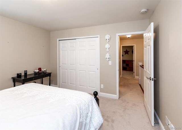 1530 Woodrose Ct, Colorado Springs, CO 80921 - bedroom featuring light colored carpet, a closet, and baseboards