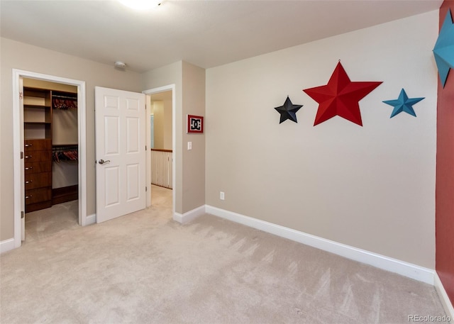 1530 Woodrose Ct, Colorado Springs, CO 80921 - unfurnished bedroom with a spacious closet, light carpet, baseboards, and a closet