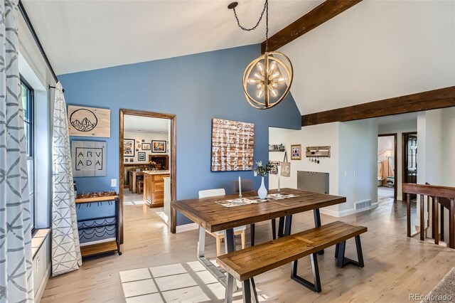 8820 W 80th Dr, Arvada, CO 80005 - dining space featuring high vaulted ceiling, a chandelier, beam ceiling, light wood-style floors, and baseboards